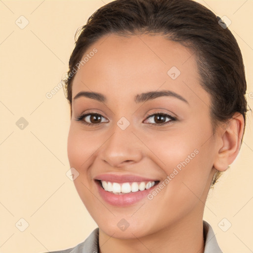 Joyful white young-adult female with long  brown hair and brown eyes