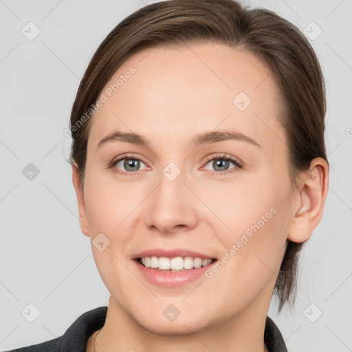 Joyful white young-adult female with medium  brown hair and grey eyes