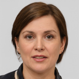 Joyful white adult female with medium  brown hair and grey eyes