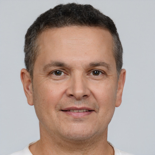 Joyful white adult male with short  brown hair and brown eyes