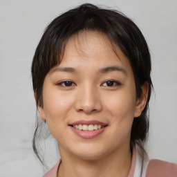 Joyful asian young-adult female with medium  brown hair and brown eyes