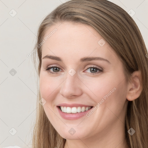 Joyful white young-adult female with long  brown hair and grey eyes