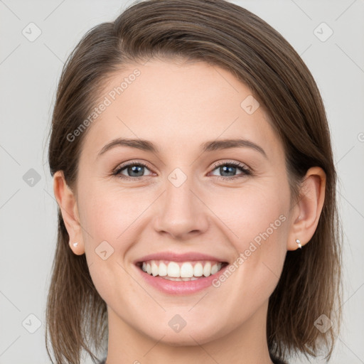 Joyful white young-adult female with medium  brown hair and grey eyes