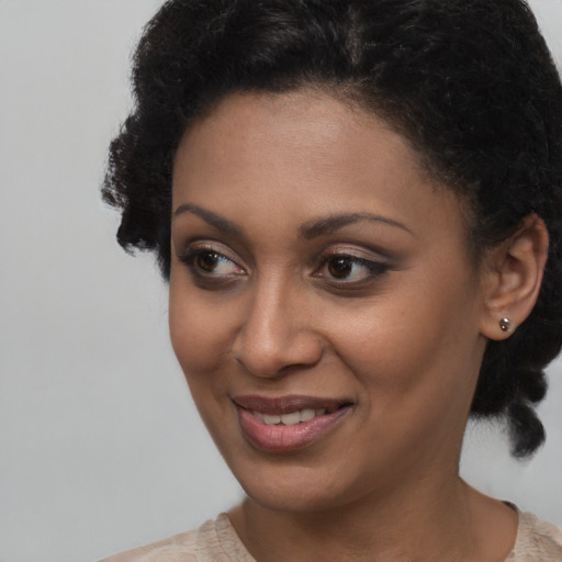 Joyful black young-adult female with short  brown hair and brown eyes