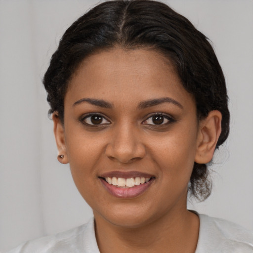 Joyful latino young-adult female with short  brown hair and brown eyes