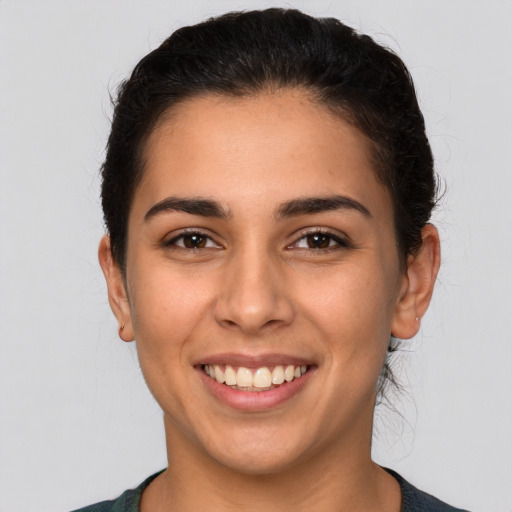 Joyful white young-adult female with short  brown hair and brown eyes