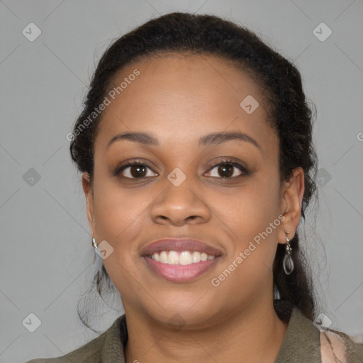 Joyful black young-adult female with long  brown hair and brown eyes