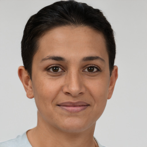 Joyful latino young-adult female with short  brown hair and brown eyes