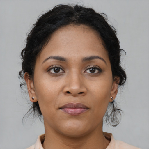 Joyful latino young-adult female with medium  brown hair and brown eyes