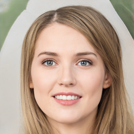 Joyful white young-adult female with long  brown hair and green eyes