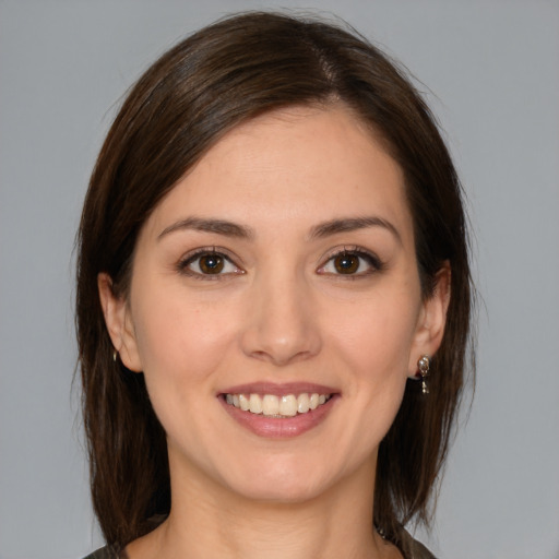 Joyful white young-adult female with medium  brown hair and brown eyes