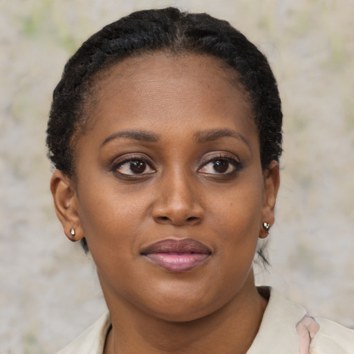 Joyful black young-adult female with short  brown hair and brown eyes