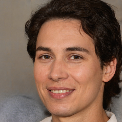 Joyful white adult male with medium  brown hair and brown eyes