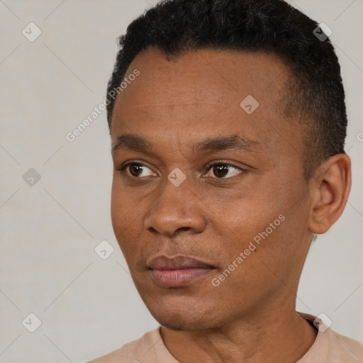 Joyful black young-adult male with short  black hair and brown eyes