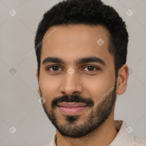 Joyful latino young-adult male with short  black hair and brown eyes