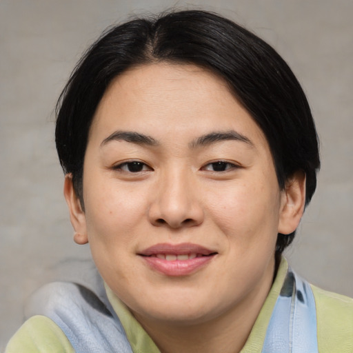 Joyful asian young-adult female with medium  brown hair and brown eyes