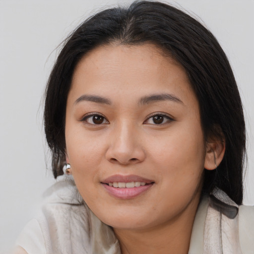 Joyful white young-adult female with long  brown hair and brown eyes