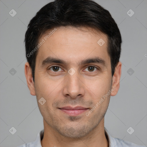 Joyful white young-adult male with short  black hair and brown eyes