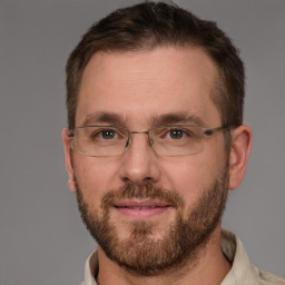 Joyful white adult male with short  brown hair and brown eyes