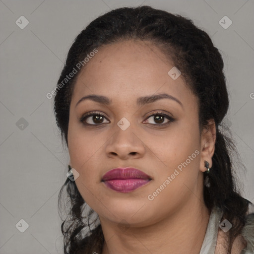 Joyful black young-adult female with long  brown hair and brown eyes