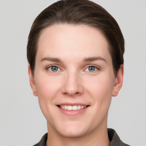 Joyful white young-adult female with short  brown hair and grey eyes