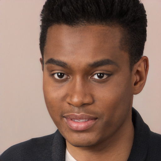 Joyful black young-adult male with short  brown hair and brown eyes