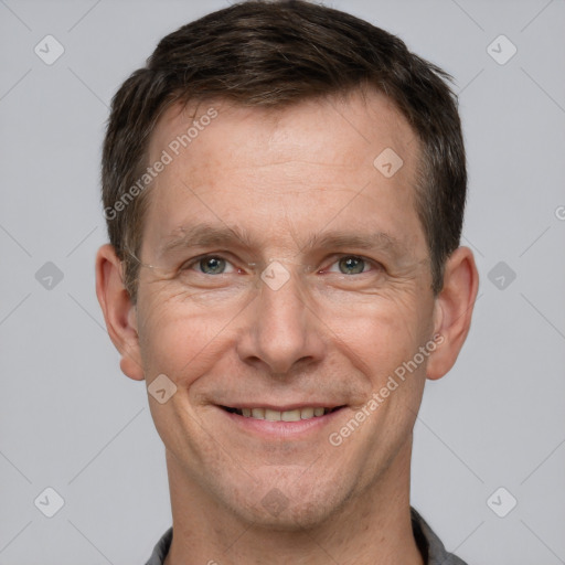 Joyful white adult male with short  brown hair and grey eyes