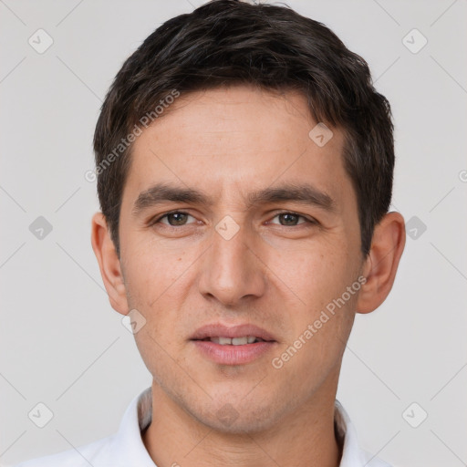 Joyful white young-adult male with short  brown hair and brown eyes