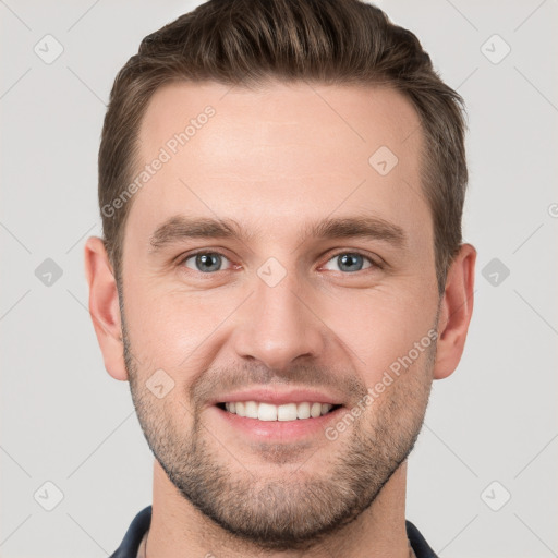 Joyful white young-adult male with short  brown hair and grey eyes