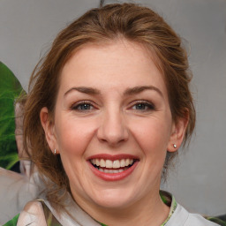 Joyful white adult female with medium  brown hair and brown eyes