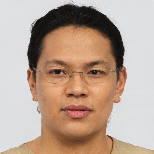 Joyful asian adult male with short  brown hair and brown eyes