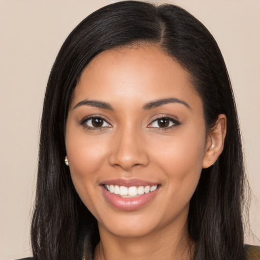 Joyful latino young-adult female with long  black hair and brown eyes