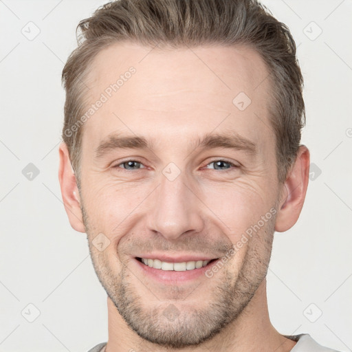 Joyful white adult male with short  brown hair and grey eyes