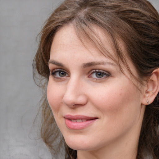 Joyful white young-adult female with medium  brown hair and blue eyes