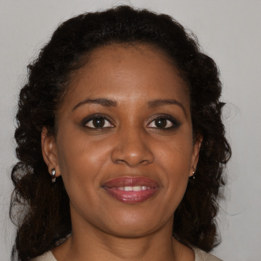 Joyful black young-adult female with medium  brown hair and brown eyes