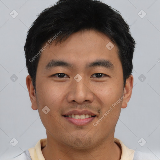 Joyful asian young-adult male with short  black hair and brown eyes