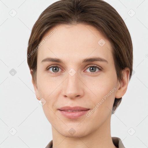 Joyful white young-adult female with short  brown hair and grey eyes