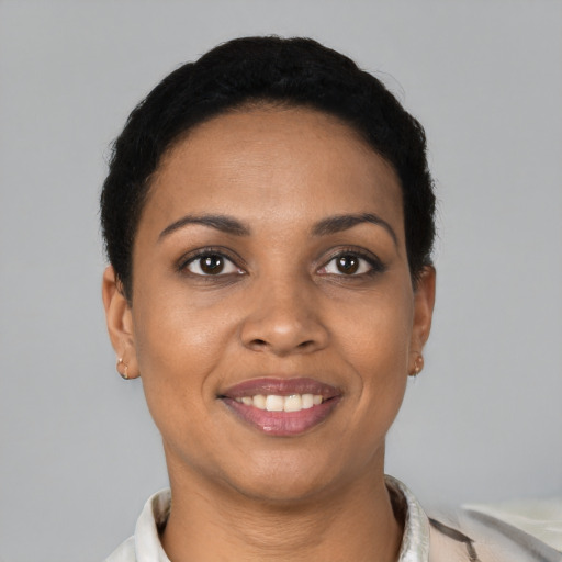 Joyful black young-adult female with short  brown hair and brown eyes