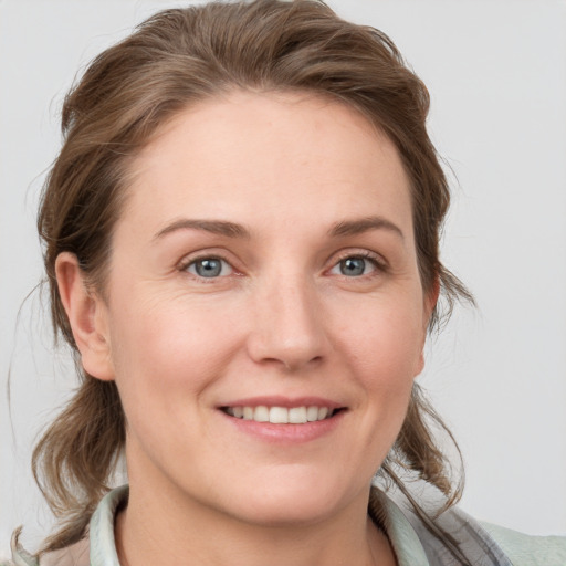 Joyful white young-adult female with medium  brown hair and blue eyes