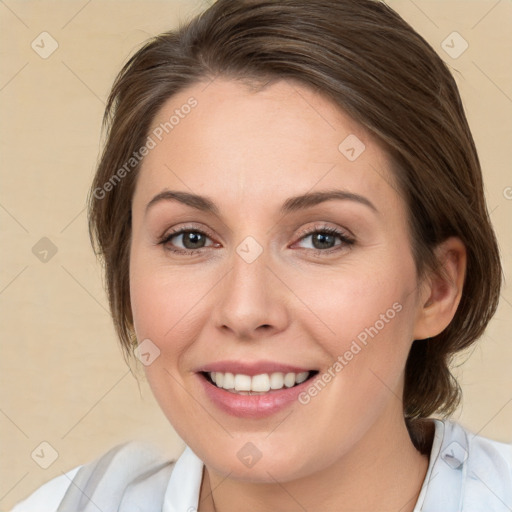 Joyful white young-adult female with medium  brown hair and green eyes