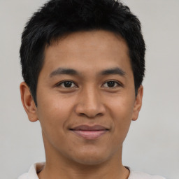 Joyful asian young-adult male with short  black hair and brown eyes