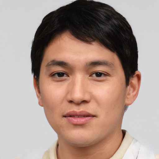Joyful asian young-adult male with short  black hair and brown eyes