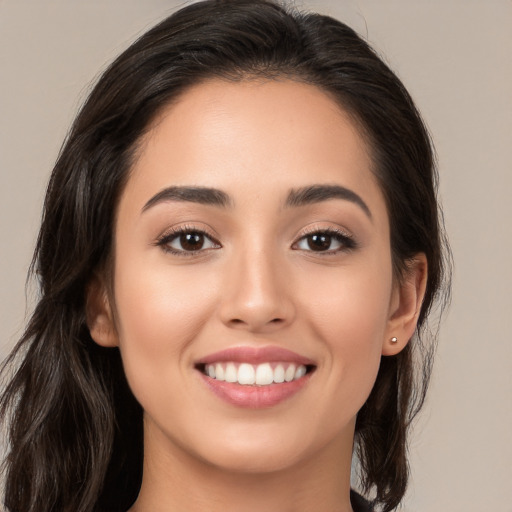 Joyful white young-adult female with long  brown hair and brown eyes