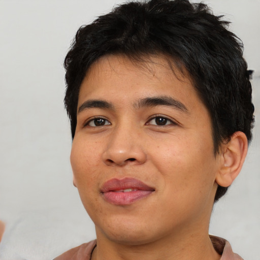 Joyful asian young-adult male with short  brown hair and brown eyes
