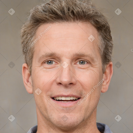 Joyful white adult male with short  brown hair and grey eyes