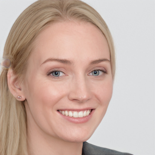 Joyful white young-adult female with long  blond hair and blue eyes