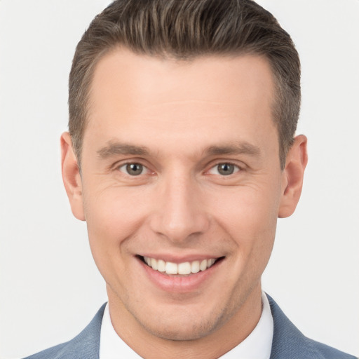 Joyful white young-adult male with short  brown hair and brown eyes