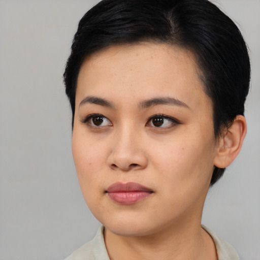 Joyful asian young-adult female with short  black hair and brown eyes