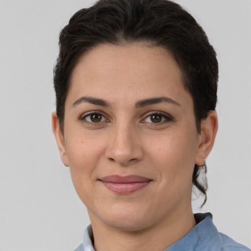 Joyful white adult female with short  brown hair and brown eyes