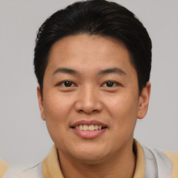 Joyful asian young-adult male with short  black hair and brown eyes